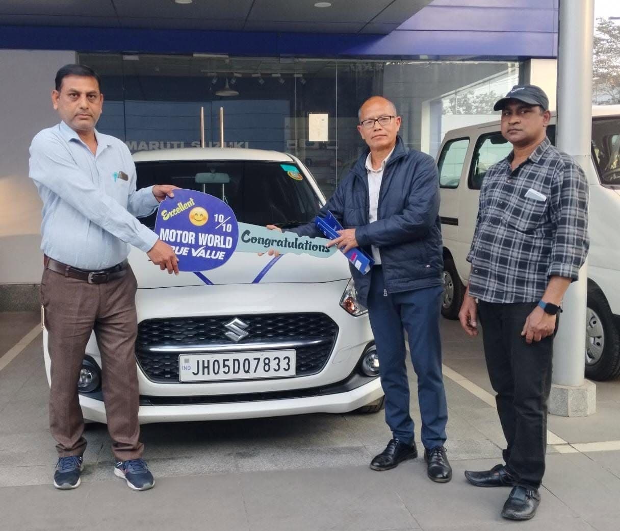 Happy customer receiving keys for Maruti Suzuki at True Value